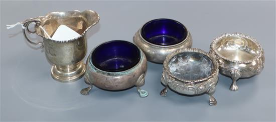 An Edwardian silver cream jug, London, 1909, a pair of Victorian silver bun slats and two other salts including Georgian.
